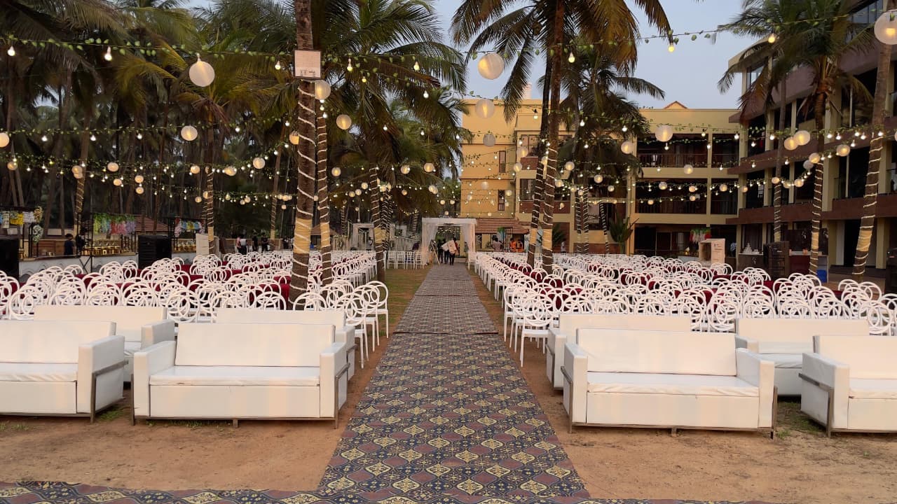 Elegant wedding venue seating arrangement with fairy lights by Shanvi Caterers